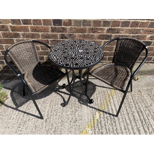 44 - A modern black metal and resin topped patio table with two chairs - table approx. 73cm high x 61cm i... 