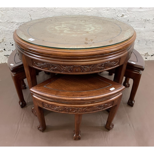 48 - A Chinese hardwood and mother of pearl inlaid circular nest of five tables on ball and claw supports... 