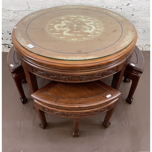 48 - A Chinese hardwood and mother of pearl inlaid circular nest of five tables on ball and claw supports... 