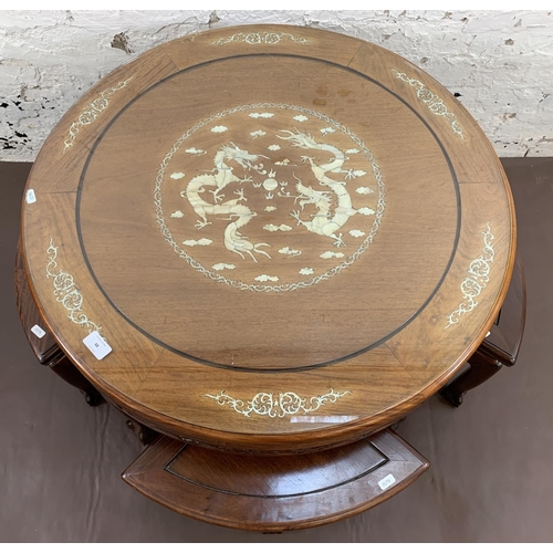 48 - A Chinese hardwood and mother of pearl inlaid circular nest of five tables on ball and claw supports... 