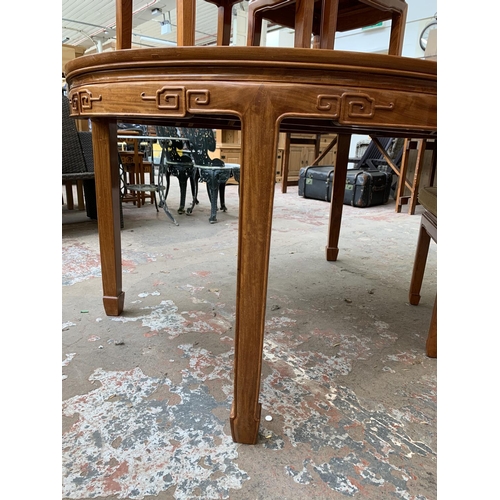 49 - A Chinese carved hardwood extending dining table and four chairs - approx. 76cm high x 157cm long x ... 