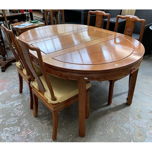 49 - A Chinese carved hardwood extending dining table and four chairs - approx. 76cm high x 157cm long x ... 