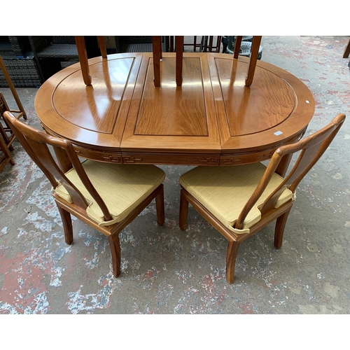 49 - A Chinese carved hardwood extending dining table and four chairs - approx. 76cm high x 157cm long x ... 