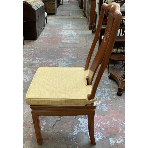 49 - A Chinese carved hardwood extending dining table and four chairs - approx. 76cm high x 157cm long x ... 