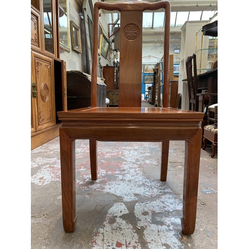 49 - A Chinese carved hardwood extending dining table and four chairs - approx. 76cm high x 157cm long x ... 