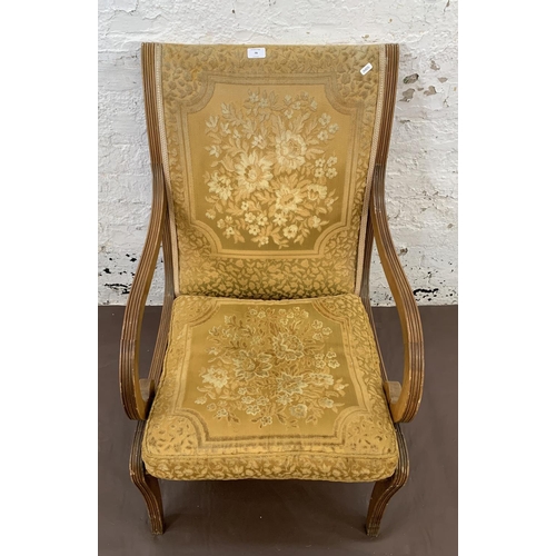 79 - A Regency style yew wood and fabric upholstered armchair