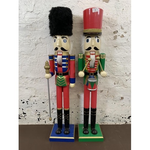 82 - Two painted wooden floor standing nut crackers, one soldier and one drummer - each approx. 92cm high