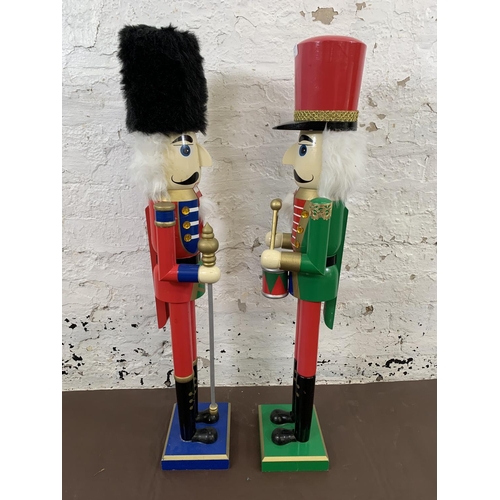 82 - Two painted wooden floor standing nut crackers, one soldier and one drummer - each approx. 92cm high