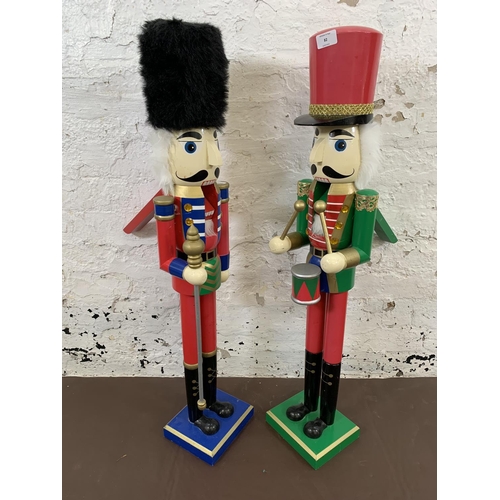 82 - Two painted wooden floor standing nut crackers, one soldier and one drummer - each approx. 92cm high