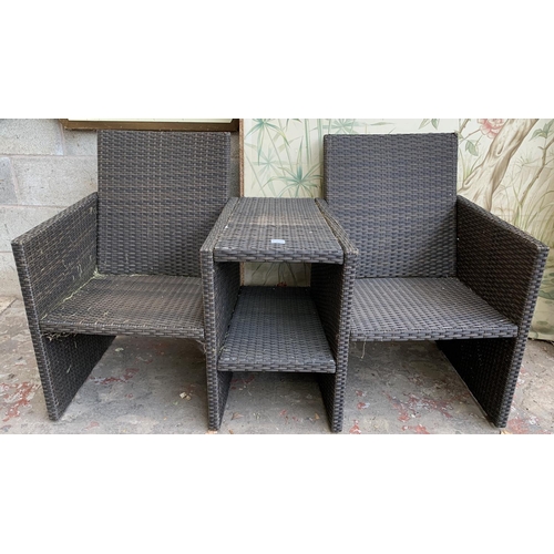 87 - A plastic rattan effect two seater garden bench with central two tier table - approx. 85cm high x 14... 