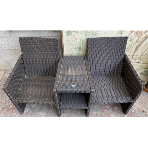 87 - A plastic rattan effect two seater garden bench with central two tier table - approx. 85cm high x 14... 