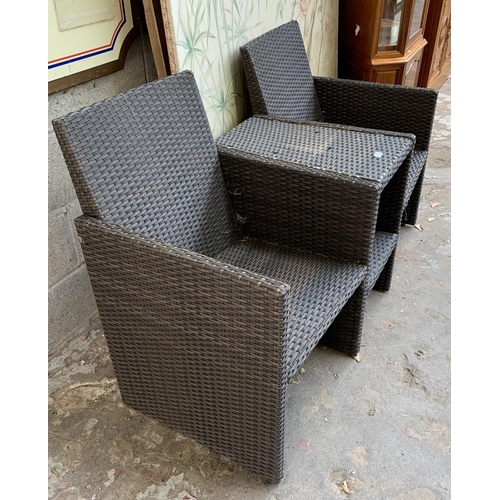 87 - A plastic rattan effect two seater garden bench with central two tier table - approx. 85cm high x 14... 