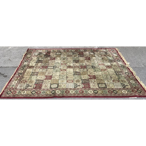 91 - A large machine woven red and cream rug - approx. 333cm long x 234cm wide