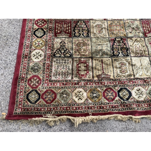 91 - A large machine woven red and cream rug - approx. 333cm long x 234cm wide