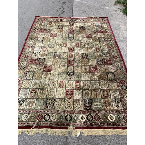 91 - A large machine woven red and cream rug - approx. 333cm long x 234cm wide