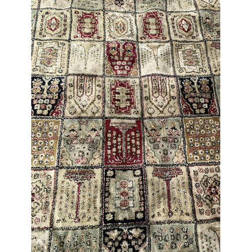 91 - A large machine woven red and cream rug - approx. 333cm long x 234cm wide