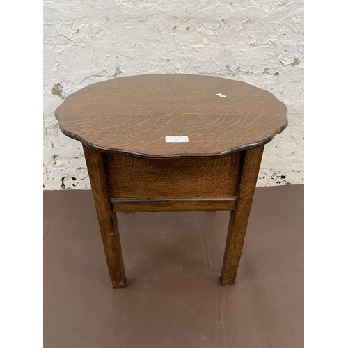 98 - A 1940s oak sewing table and contents - approx. 46cm high x 49cm diameter