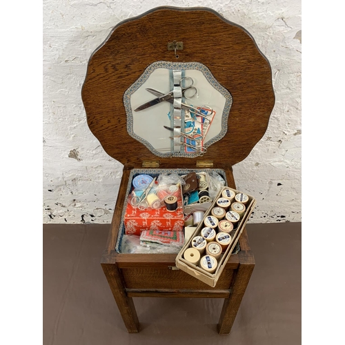 98 - A 1940s oak sewing table and contents - approx. 46cm high x 49cm diameter