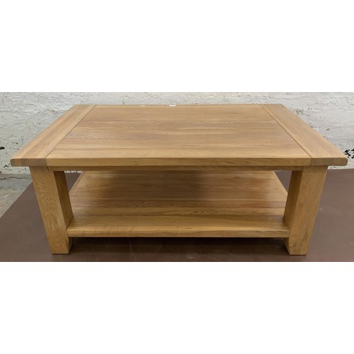 97 - A modern solid oak rectangular two tier coffee table - approx. 50cm high x 70cm wide x 120cm long