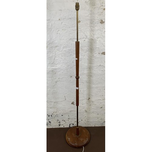 124 - A 1960s teak and brass standard lamp - approx. 143cm high