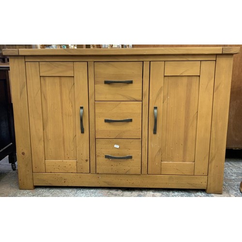 127 - A modern pine sideboard with three drawers and two cupboard doors - approx. 76cm high x 115cm wide x... 