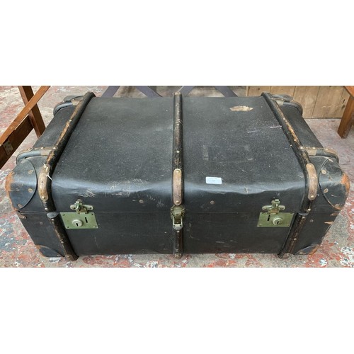 19 - A vintage black fibreboard and wooden banded travel trunk - approx. 34cm high x 85cm wide x 53cm dee... 