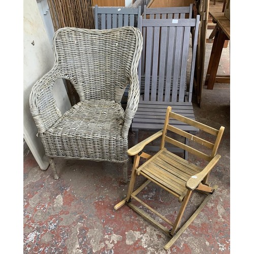 20 - Five pieces of furniture, three wooden grey painted folding garden chairs, one wicker armchair and o... 