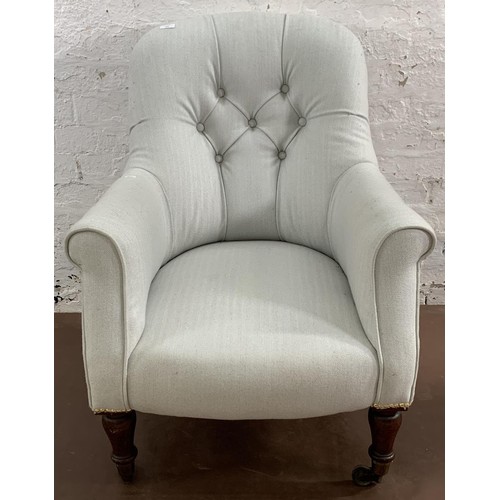 74 - A Victorian Saville Row blue and white fabric upholstered button back armchair on rosewood supports ... 