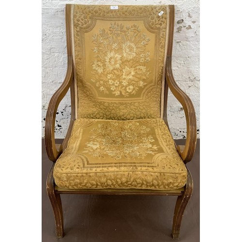 79 - A Regency style yew wood and fabric upholstered armchair