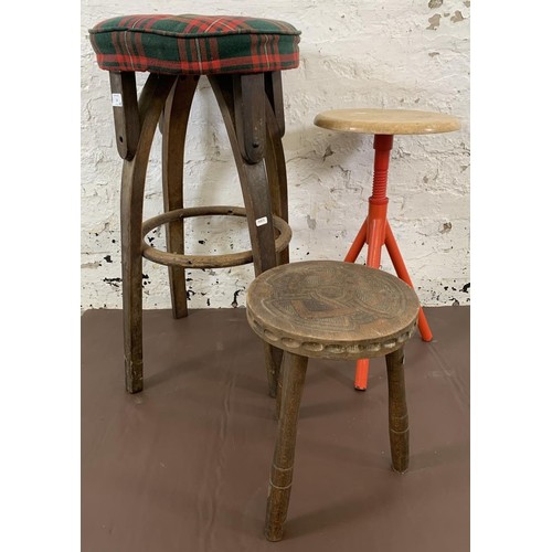 24 - Three stools, vintage bentwood barstool - approx. 72cm high, carved elm milking stool - approx. 35cm... 