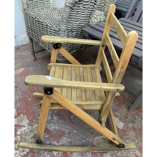 20 - Five pieces of furniture, three wooden grey painted folding garden chairs, one wicker armchair and o... 