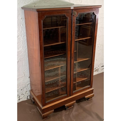 5 - A 19th century mahogany two door glazed display cabinet with Horne patent brass hinges and pigeon ho... 