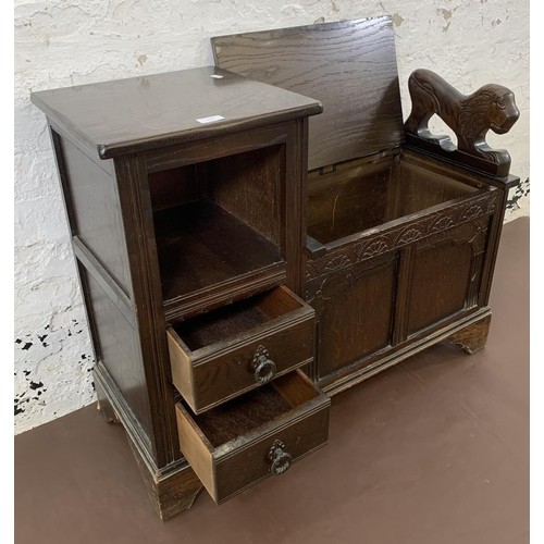 112 - A vintage oak telephone table with carved lion armrest, storage chest and two drawers - approx. 73cm... 