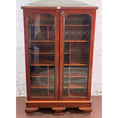 5 - A 19th century mahogany two door glazed display cabinet with Horne patent brass hinges and pigeon ho... 