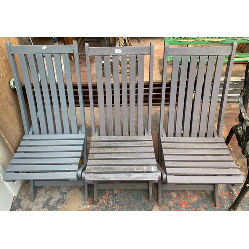 20 - Five pieces of furniture, three wooden grey painted folding garden chairs, one wicker armchair and o... 