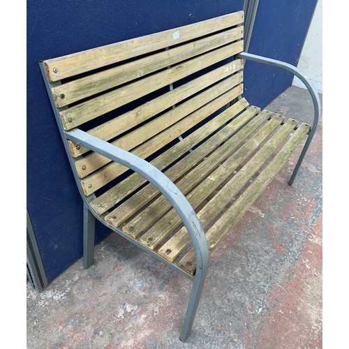 145 - A metal and wooden slatted garden bench - approx. 82cm high x 119.5cm wide x 47.5cm deep