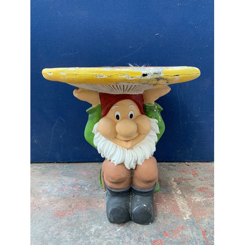 146 - A fibreglass and painted garden gnome circular table - approx. 67cm high x 65cm diameter