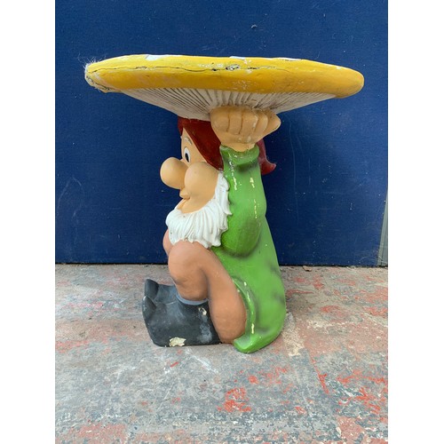 146 - A fibreglass and painted garden gnome circular table - approx. 67cm high x 65cm diameter