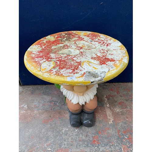 146 - A fibreglass and painted garden gnome circular table - approx. 67cm high x 65cm diameter