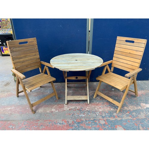 149 - A three piece wooden slatted garden patio table and chair set