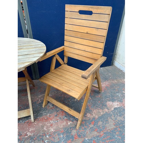 149 - A three piece wooden slatted garden patio table and chair set