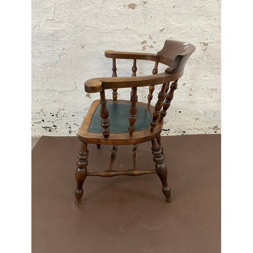 150 - A 19th century elm and mahogany bow back smokers armchair with green vinyl and brass studded seat pa... 