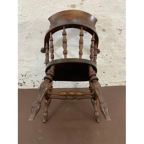 150 - A 19th century elm and mahogany bow back smokers armchair with green vinyl and brass studded seat pa... 