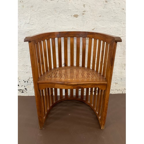 151 - A teak and rush seated barrel back armchair - approx. 85cm high x 65cm wide x 48cm deep