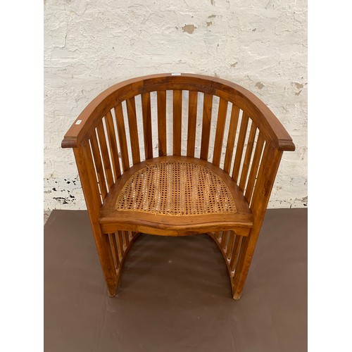 151 - A teak and rush seated barrel back armchair - approx. 85cm high x 65cm wide x 48cm deep