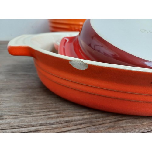 935 - Seven items of Le Creuset stoneware, one mixing bowl, one large and two small rectangular dishes, on... 