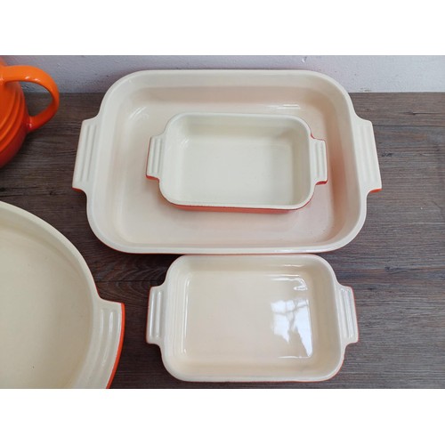 935 - Seven items of Le Creuset stoneware, one mixing bowl, one large and two small rectangular dishes, on... 