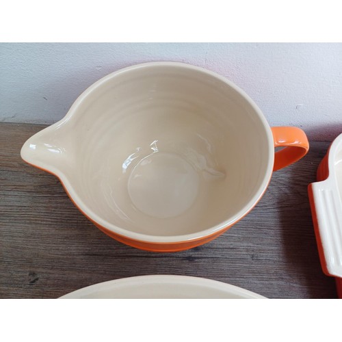 935 - Seven items of Le Creuset stoneware, one mixing bowl, one large and two small rectangular dishes, on... 