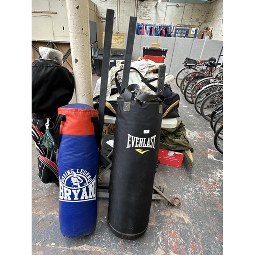 1021 - Two punching bags, one Everlast and one Bryan Boxing Legend with stand