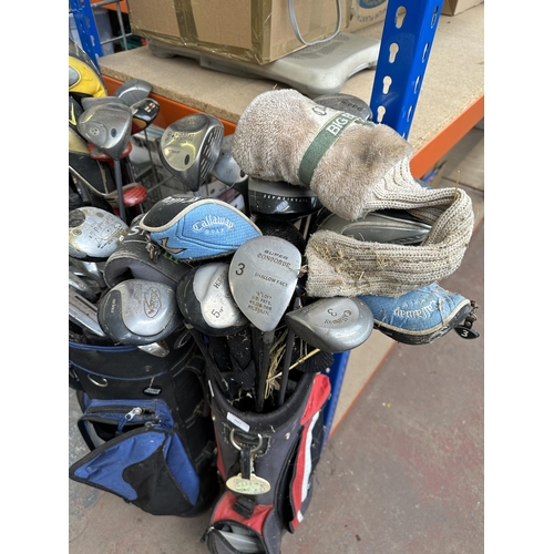 1022 - Three golf bags containing clubs to include Slazenger, Wilson, Hippo, Callaway etc.